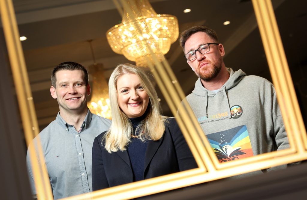 two men and a woman posing in a mirror
