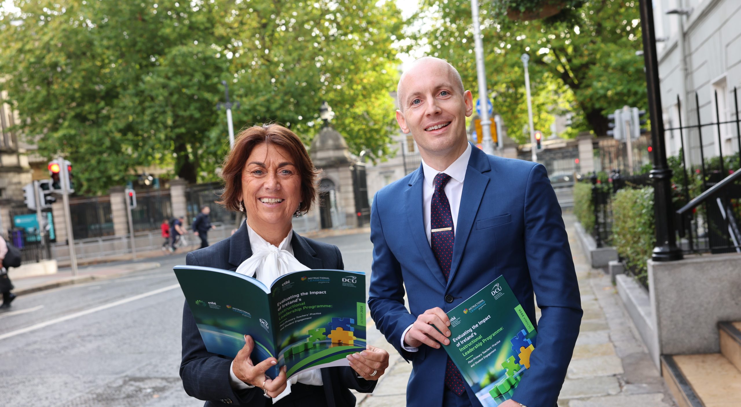 Woman and man holding promotional booklet