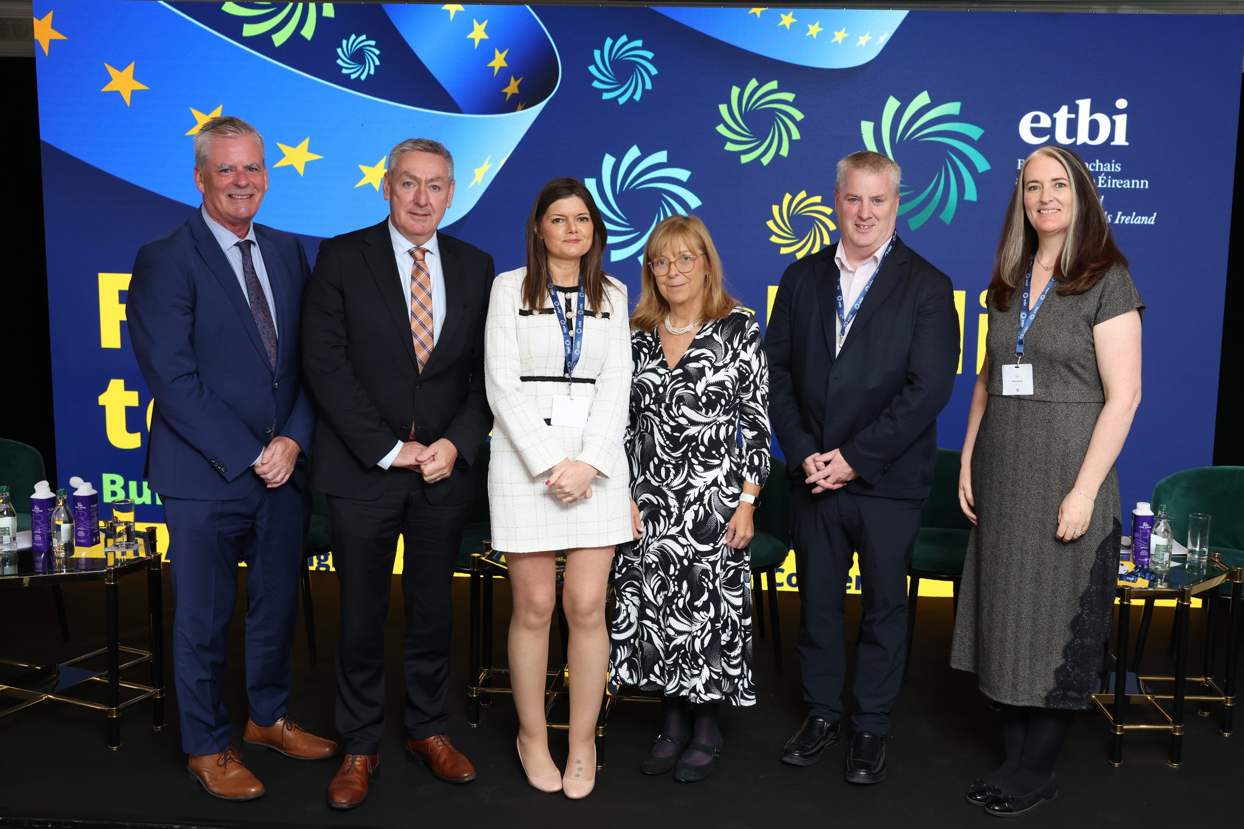 Panelists from the first session standing in front of Ballinskelligs to Brussels branded wall